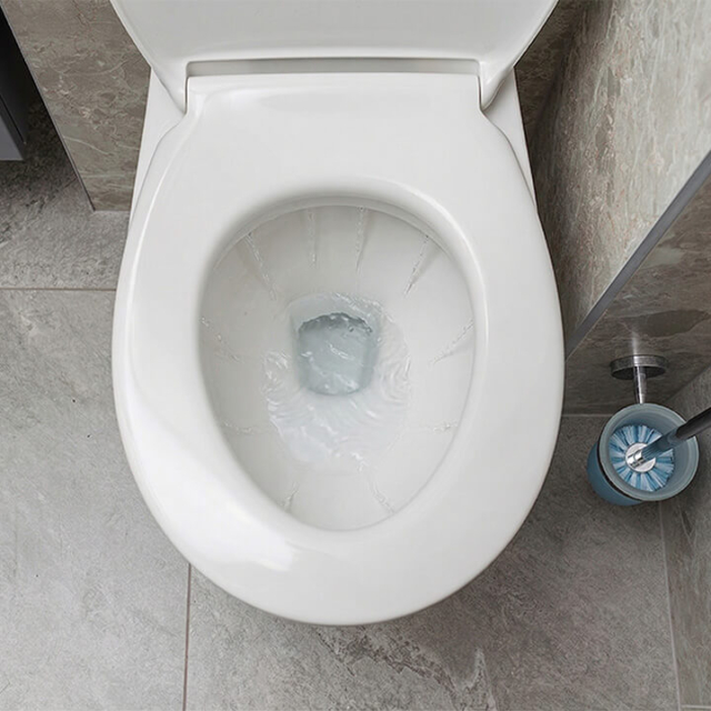 Looking down at a toilet that has water continuously flowing into the bowl