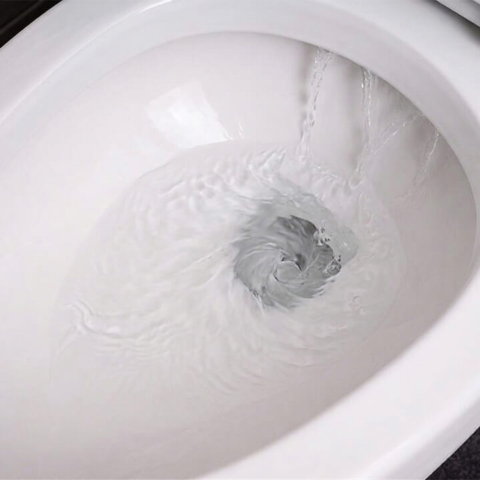Close-up of a clean toilet with a weak flush