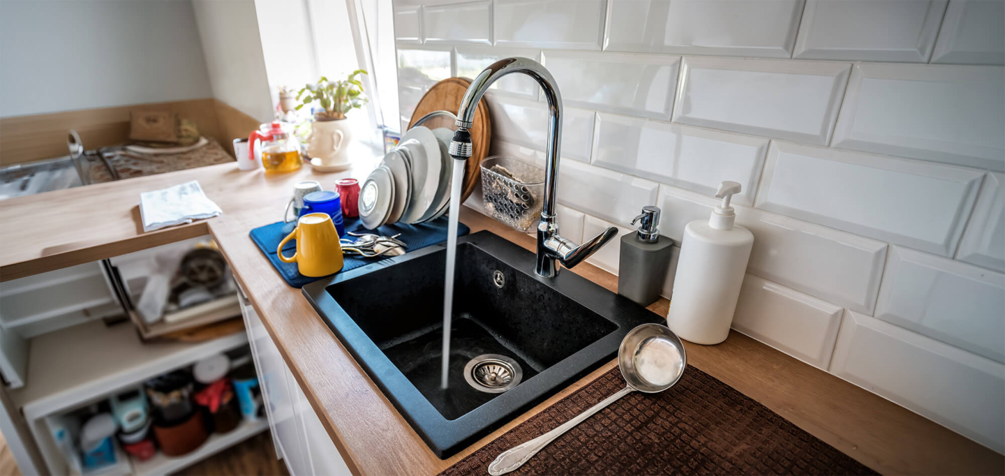 Kitchen sink with running water in a clean and modern kitchen