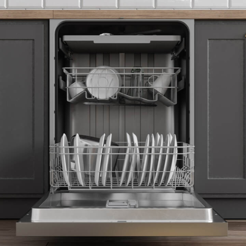 A modern, open dishwasher filled with clean dishes and connected to a professional water line, ensuring maximum appliance efficiency through expert plumbing installation services.