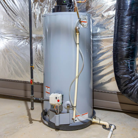 A modern gas-powered storage water heater installed in a residential basement, highlighting professional plumbing maintenance and installation services.